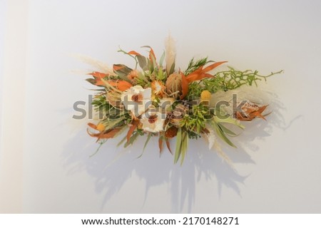Dried flower swag decorated on white walls Royalty-Free Stock Photo #2170148271