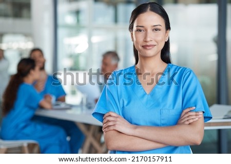 Being a nurse is not easy. Shot of a young nurse in the midst of a staff meeting. Royalty-Free Stock Photo #2170157911