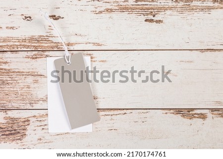 white Blank tag on a light wooden background