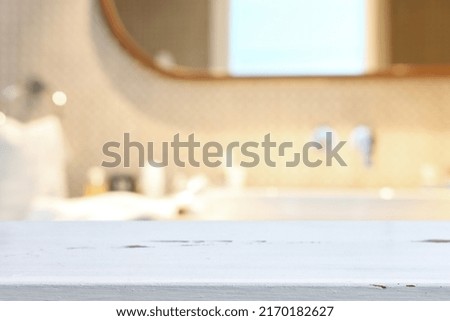 empty table board and defocused indoor bathroom background. product display concept