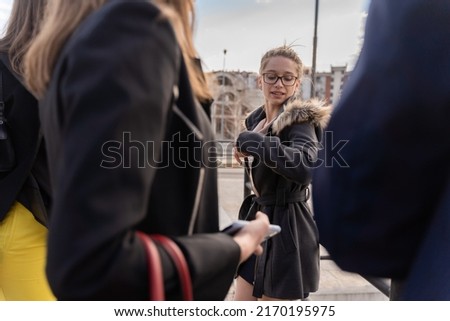 Attractive and amazing young bussines woman is listening to her co workers while explaining something