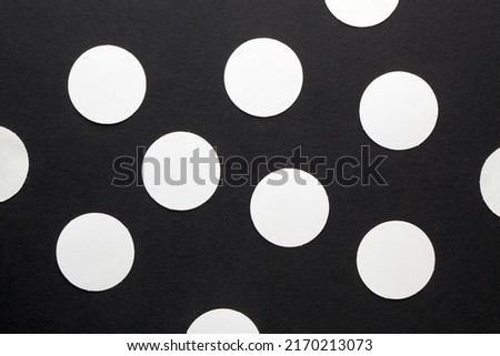 White paper circles on black background. Design element.