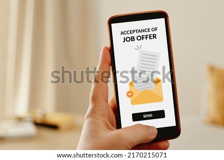 Female hand sending an email from mobile phone to accept a job offer. Royalty-Free Stock Photo #2170215071
