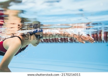 Woman swimming pool . Underwater photo
