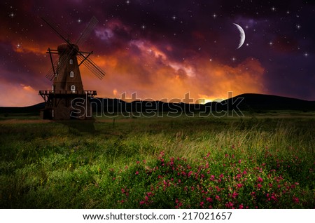 Windmill in the night. Elements of this image furnished by NASA.