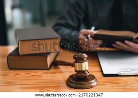 Attorney reading law code, studying constitution to protect human rights closeup, Male lawyer or judge working with Law books, gavel