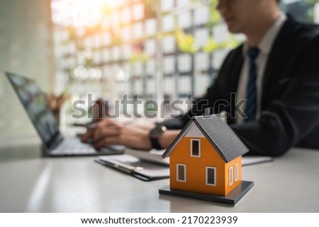 Real estate, buy house concept, Real estate agents are printing house purchase contract documents. and bank loans for buying and selling houses and land.