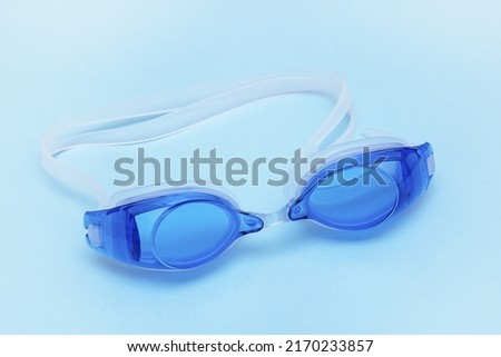 swimming goggles on a blue background, sports, summer, leisure