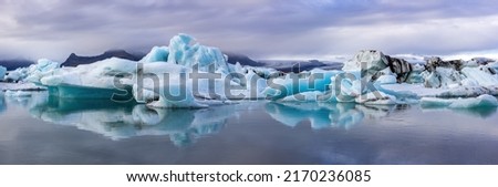 Wide panorama of the Jokulsarlon Glacial lagoon, Southern Iceland. Mirror reflection of the blue ice icebergs. Vatnajokull National Park. Royalty-Free Stock Photo #2170236085