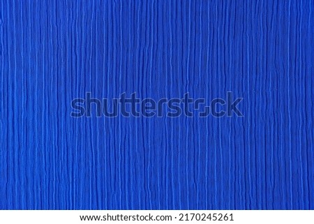 Top view of dark blue crinkled and crumpled fabric texture. Seamless pattern cloth abstract background Royalty-Free Stock Photo #2170245261