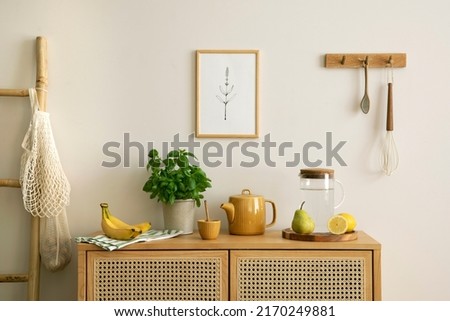 Interior design of kitchen space with mock up poster, rattan commode,  ladder, herbs, vegetables, food and kitchen accessories in modern home decor.  Template. 