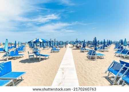Beach on Italian riviera with walkway to seashore Royalty-Free Stock Photo #2170260763