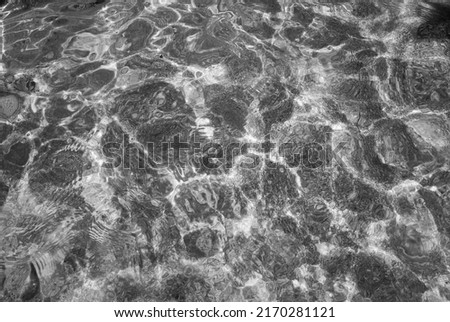 Blurred focus. Black and white photograph of a sandy seabed.