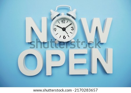 Now Open alphabet letters on blue background Royalty-Free Stock Photo #2170283657