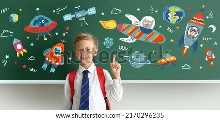 Little schoolboy near blackboard with drawn space