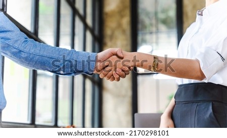 Team of Asian businessmen and women shake hands together to create a mutually beneficial business relationship. Royalty-Free Stock Photo #2170298101
