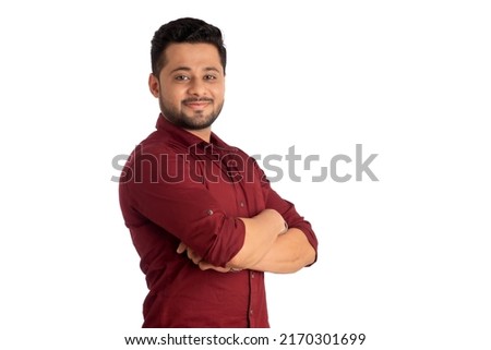 Portrait of a happy young man posing with arms crossed or hands folded on a white background Royalty-Free Stock Photo #2170301699