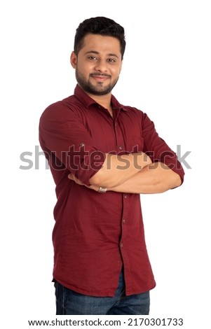 Portrait of a happy young man posing with arms crossed or hands folded on a white background Royalty-Free Stock Photo #2170301733