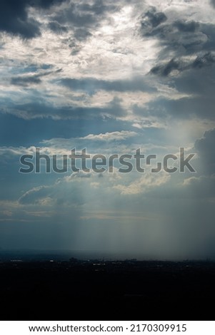 Dark storm clouds sky and thunderstorm with the rain, nature Background, Dark ominous grey storm clouds. Dramatic sky ray.