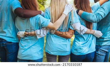 Volunteering, people and ecology concept. Group of volunteers embracing in park, back view, copy space



 Royalty-Free Stock Photo #2170310187