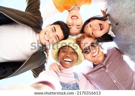 Smiling low angle circle selfie of cheerful group of young people. Happy friends excited having fun. Boys and girls taking picture looking at camera smart mobile phone.