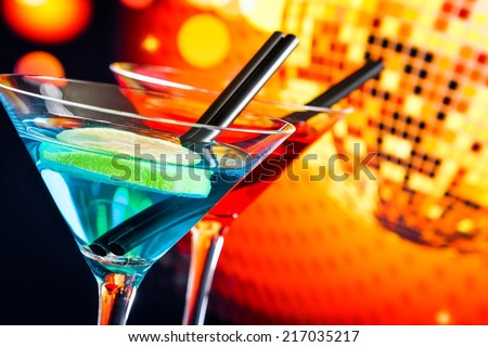 blue and red cocktail with sparkling disco ball background with space for text, dance disco concept