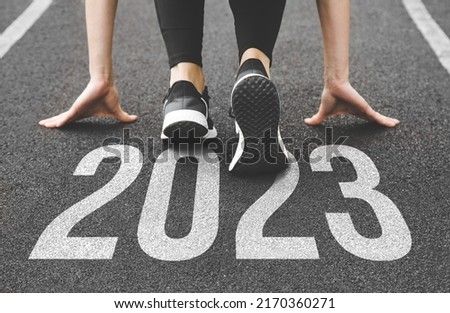 close-up of feet in sneakers at the start. Beginning and start of the new year 2023, goals and plans for the next year Royalty-Free Stock Photo #2170360271