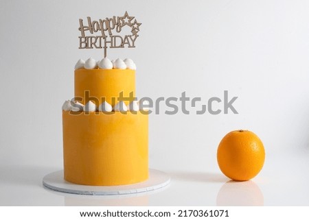 Orange and blue mini tiered birthday cakes. Royalty-Free Stock Photo #2170361071