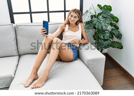 Young caucasian woman smiling confident making selfie by the smartphone at home