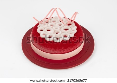 Glazed mousse cakes in different designs on a white background.