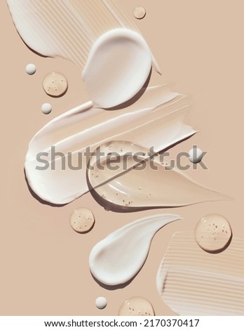 cosmetic smears of creamy texture on a pastel beige background Royalty-Free Stock Photo #2170370417