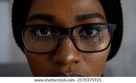 Close-up of a smart business woman wearing computer glasses looking at a computer screen, using the Internet, reading information, watching, working on the Internet. Royalty-Free Stock Photo #2170375925