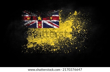 brush painted flag of Niue isolated on black background