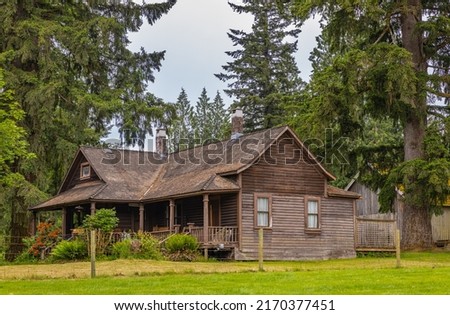 Typical traditional wooden cottage at summer day in the countryside. Wooden house in the forest in Canada. Travel photo, nobody, selective focus Royalty-Free Stock Photo #2170377451