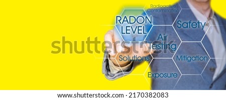 The danger of radon gas - concept with business manager pointing to icons against a digital display - image with copy space for text insertion