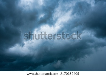 Moody dramatic blue sky and stormy cloud during thunderstorm background