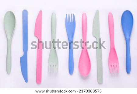 Cutlery set made of wheat straw of pastel colors in a row on white background. Reusable utensils. School lunch concept Royalty-Free Stock Photo #2170383575