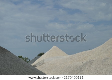 White sand dunes within the factory for the production of concrete and asphalt for roads, quality industrial material