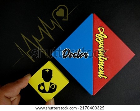 Hand holding yellow wooden block with doctor icon and text Doctor Appointment at triangle wooden block with heart beat icon on black background 