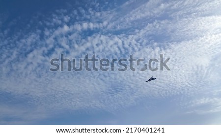 Beautiful full clouds on deep blue sky background. Elegant many small rainy and tiny glowing soft white fluffy clouds covered the entire blue sky. Altocumulus clouds (Rows of fluffy clouds) Royalty-Free Stock Photo #2170401241