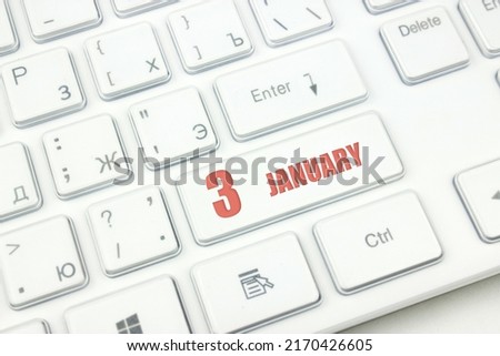 January 3rd. Day 3 of month, Calendar date. Cropped view of Modern White Computer Keyboard with calendar date. Concept workspace, freelance, deadline.  Winter month, day of the year concept