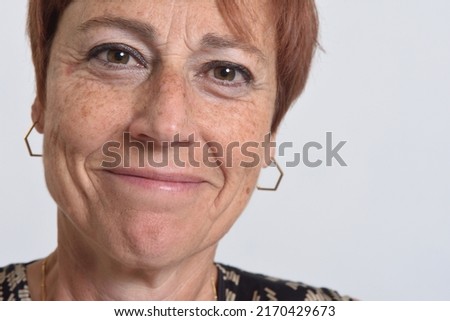 close up of a  middle aged woman smiling on white background Royalty-Free Stock Photo #2170429673