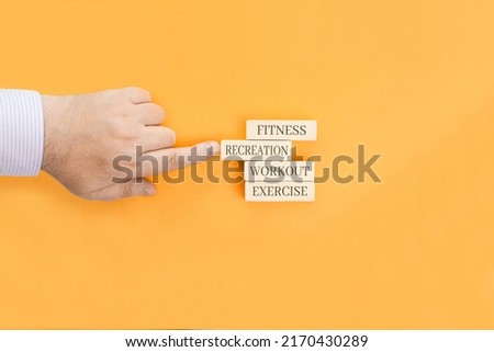 Basic health concepts - words written on wooden blocks. Fitness, recreation, workout, exercise are concepts associated with a healthy lifestyle.