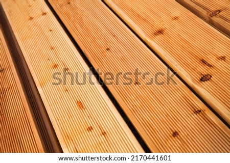 Larch deck boards flooring, close up photo with perspective effect
