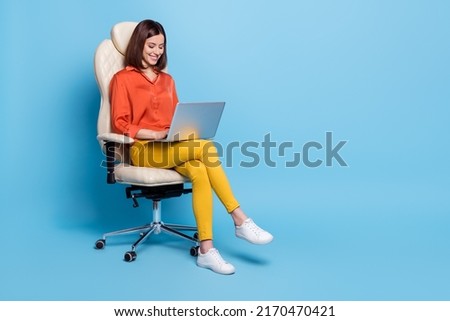 Full length body size view of attractive cheerful focused girl writing email isolated over bright blue color background Royalty-Free Stock Photo #2170470421