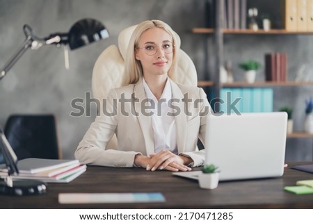 Photo of friendly positive lady agent smiling working modern device indoors workstation workshop
