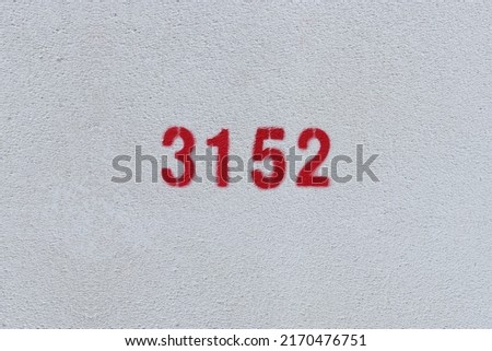 Red Number 3152 on the white wall. Spray paint.
