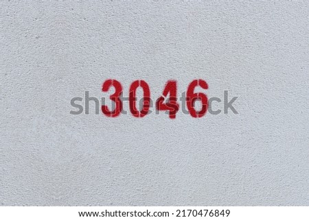Red Number 3046 on the white wall. Spray paint.
