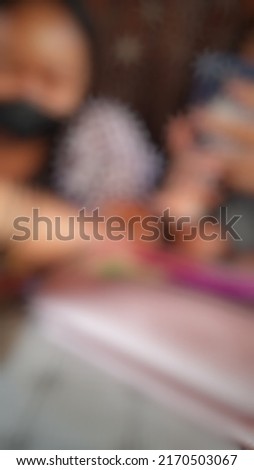 Defocused or blurred abstract background of a female student reading a book