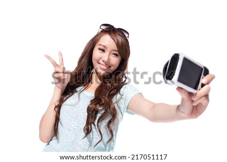 Happy travel young girl selfie taking pictures of herself isolated over white background, asian